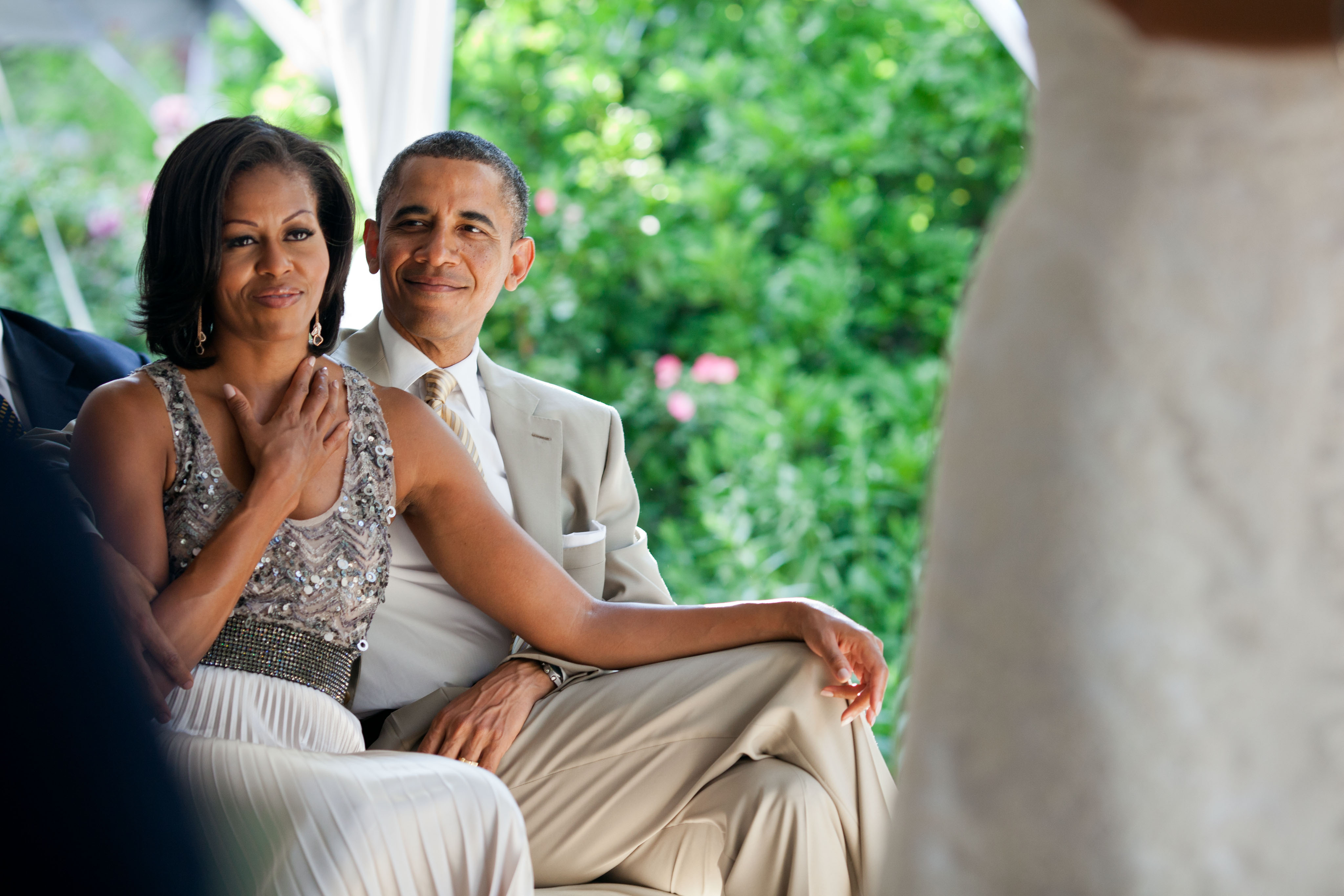 June 18, 2012 "The First Lady reacts as she watches Laura Jarrett and Tony Balkissoon take their vows during their wedding at Valerie Jarrett's home in Chicago." (Official White House Photo by Pete Souza) This official White House photograph is being made available only for publication by news organizations and/or for personal use printing by the subject(s) of the photograph. The photograph may not be manipulated in any way and may not be used in commercial or political materials, advertisements, emails, products, promotions that in any way suggests approval or endorsement of the President, the First Family, or the White House.