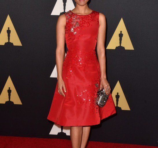 Splurge: Gugu Mbatha-Raw’s 2014 Governors Awards Oscar de la Renta Red Bell Shape Beaded Dress, Embellished Satin Box Clutch, and Jimmy Choo Black Peep Toe Ankle Strap Sandals
