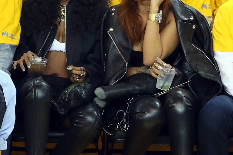 Get the Look: Rihanna’s NBA Finals Game One Tom Ford Over The Knee Napa Stretch Boots With Metal Stiletto, Acne Studios Oversized Leather Jacket and Dominic Louis x Mandy Coon Black Leather Bunny Backpack