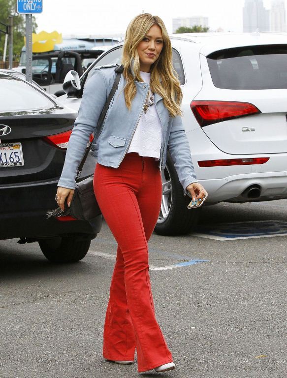 Splurge: Hilary Duff’s Studio City IRO Cropped Biker Jacket, Koral High Rise Flared Jeans, and Proenza Schouler PS1 Mini Fringed Satchel