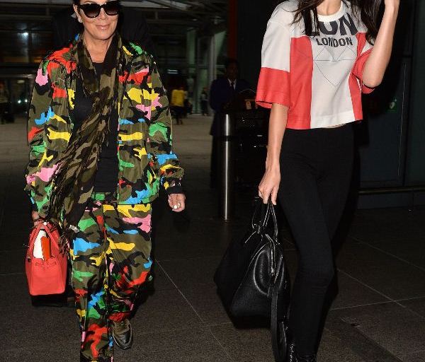 Splurge: Kris Jenner’s Heathrow Airport Valentino Men’s Camouflage Print Jacket, Multicolor Happy Camo Jogging Pants, and Camupeace Camo Print Leather Sneakers