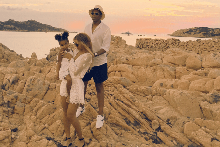 Get the Look: Beyonce’s Italian Vacation Zimmermann White Lucia Silk Embroidered Playsuit, Black Marisol Wired One Piece Swimsuit, and Rhythm Dot Tuck Playsuit