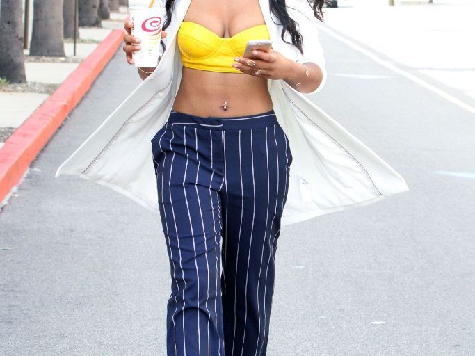Splurge: Keke Palmer’s WB Studios Armani Exchange V-Neck Tunic Blazer, Yellow Moschino Bra Top, Striped Pants, and Tamara Mellon Tiger Patent Leather Sandals
