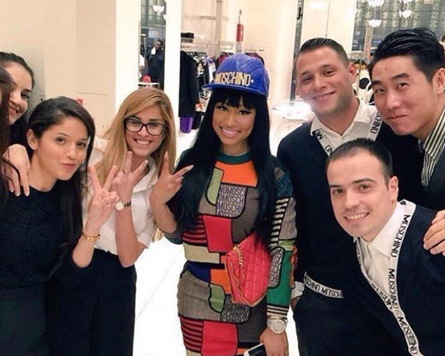 Splurge: Nicki Minaj’s Instagram Moschino Cobalt Leather Quilted Logo Cap, Multicolor Patchwork Sweater, and Patchwork Knit Mini Skirt