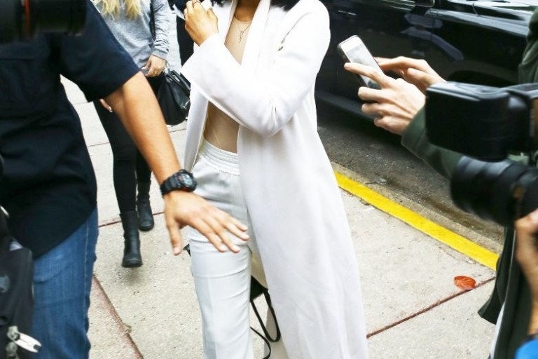 Get the Look: Kylie Jenner’s Miami Victoria Beckham Classic Victoria Gold Mirrored Sunglasses, The Row Nalaton Coat, Maison Martin Margiela Stretch Jersey Bodysuit, 3.1 Phillip Lim Straight Leg Pants, and Acne Studios Adrian Sneakers