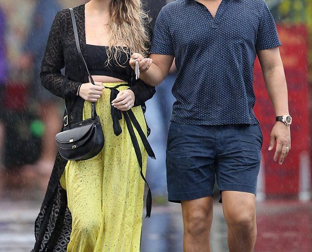 Get the Look: Chrissy Teigen’s Hawaii Dior Metallic Sunglasses, Nookie Black Sheer Wrap Maxi Dress, Proenza Schouler Printed Cotton and Silk Blend Wide Leg Pants, Chloe Georgia Mini Leather Shoulder Bag, and Ancient Greek Chrysso Beaded Leather Sandals