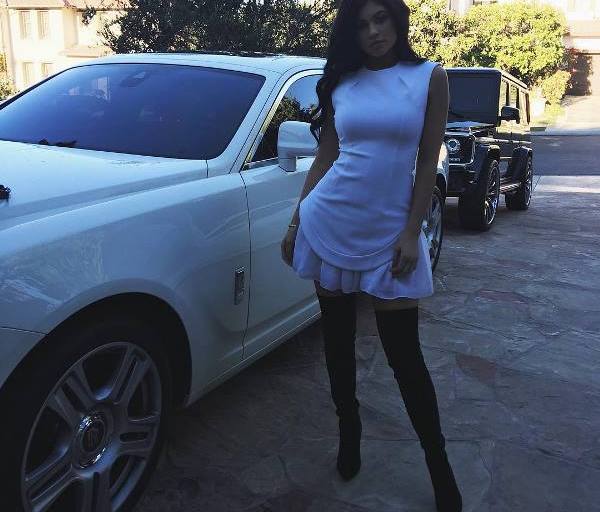 Splurge: Kylie Jenner’s Instagram Cushnie et Ochs White Curve Cap Sleeve Dress and Brian Atwood Black Odille Suede Thigh High Boots