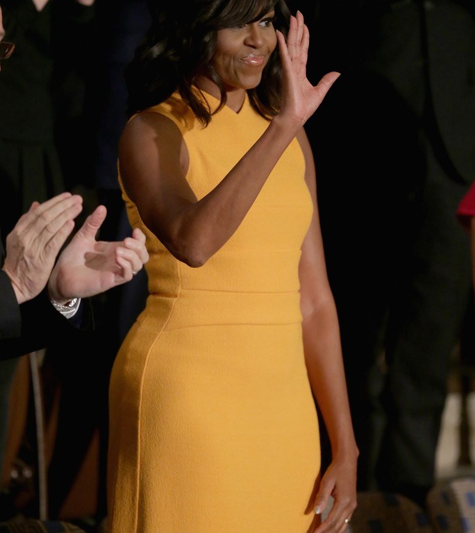 First Lady Michelle Obama in a Narciso Rodriguez Marigold Sleeveless Flared Dress at President Obama’s Last State of the Union Address