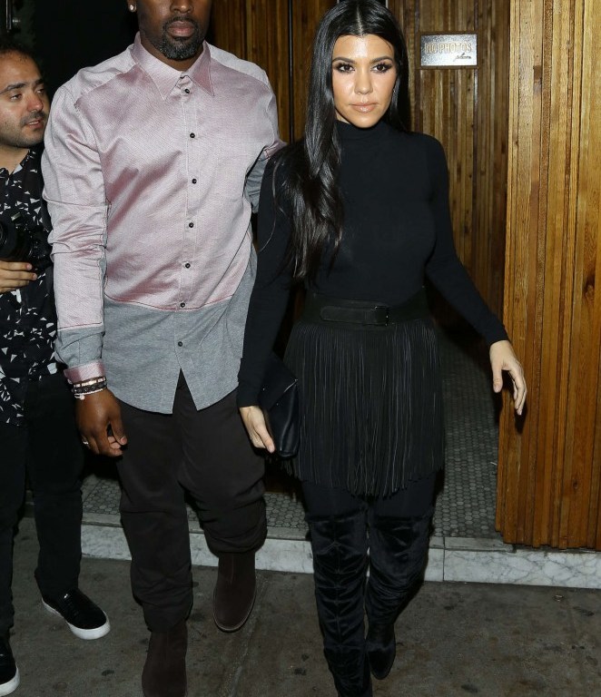 Splurge: Kourtney Kardashian’s The Nice Guy Wolford Black Luxe Pullover Turtleneck, Azzedine Alaia Black Fringed Suede Belt, and Aquazzura Black Velvet Over The Knee Boots