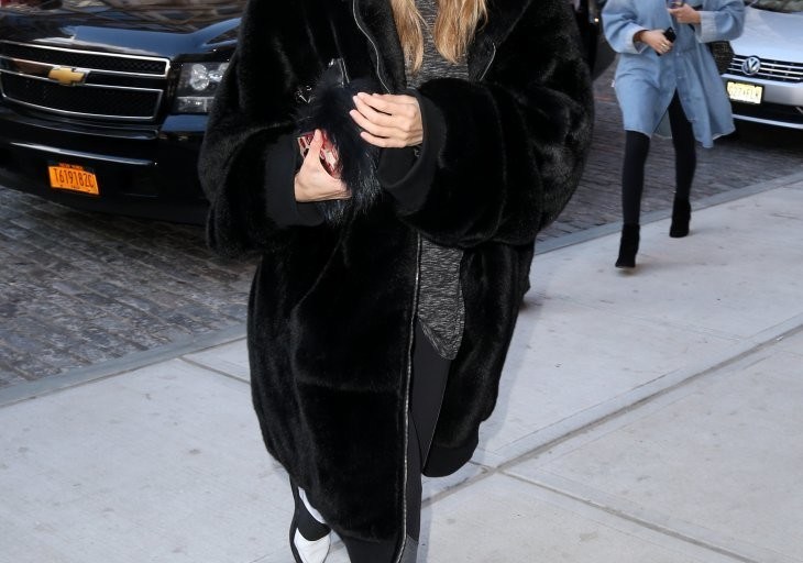 Get the Look: Gigi Hadid’s New York City FENTY x PUMA Fall 2016 Black Hooded Fur Coat, Elizabeth and James Wythe Sunglasses, Splits 59 Langley Tights, and Filling Pieces Elastic Band Leather Sneakers