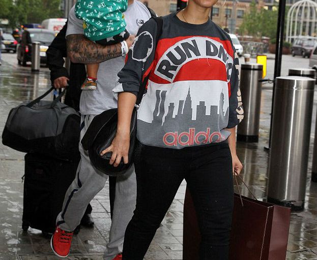 Splurge: Alicia Keys’s St. Pancras Train Station Vintage ’80s Run DMC My Adidas Sweatshirt and Alaïa Leather Wedge Ankle Boots