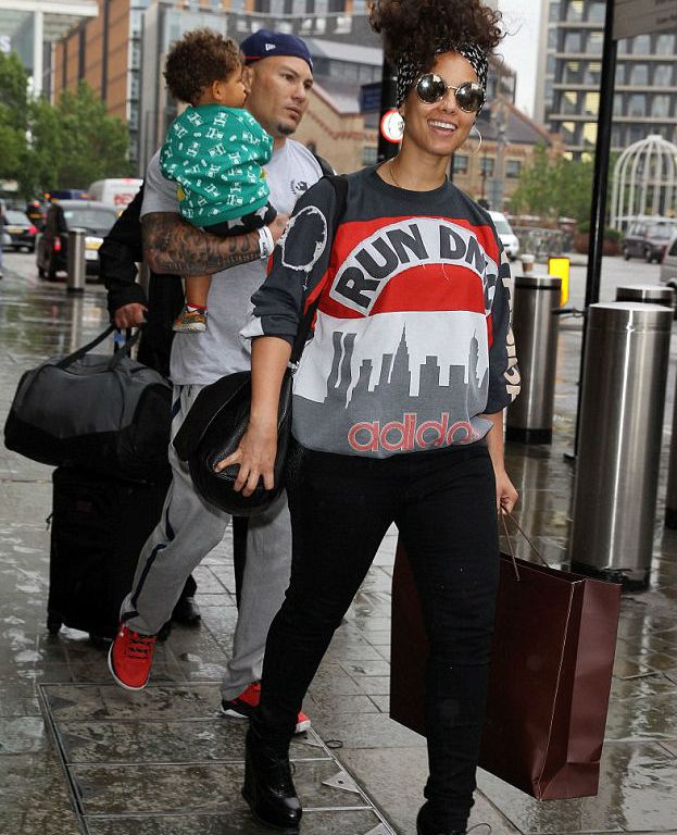 Splurge: Alicia Keys’s St. Pancras Train Station Vintage ’80s Run DMC My Adidas Sweatshirt and Alaïa Leather Wedge Ankle Boots