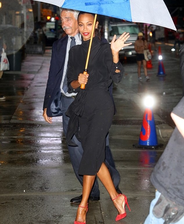 Splurge: Zoe Saldana’s <em>The Late Show with Stephen Colbert</em> Victoria Beckham Black Crepe de Chine Knot Blouse, Matching High Waisted Pencil Skirt, and Christian Louboutin ‘Uptown’ Red Ankle Strap Pumps