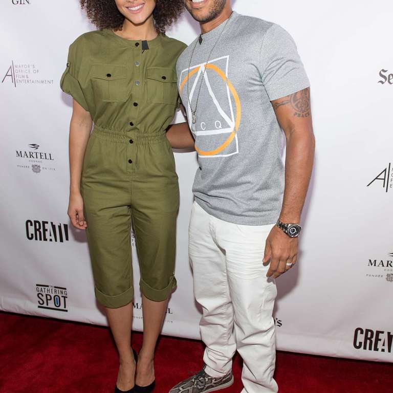 Splurge: Nathalie Emmanuel’s <em>Fast8</em> Atlanta Panel Discussion Vanessa Seward Green Bacan Jumpsuit and Ludacris’s McQ by Alexander McQueen Gray Mouline Logo Print Short Sleeve T-Shirt and Del Toro Faux Python Chukka Sneakers
