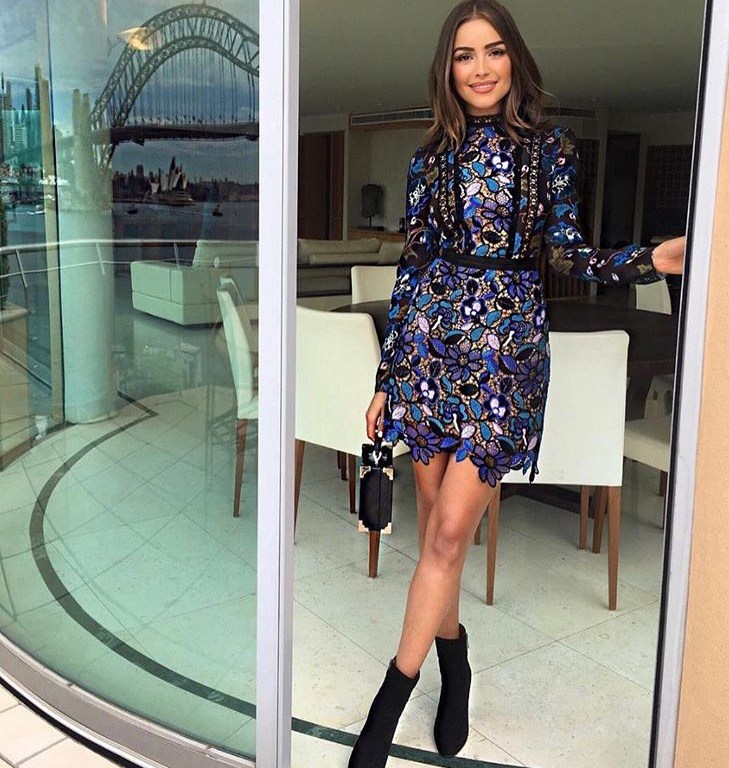 Splurge: Olivia Culpo’s <em>Morning Show on 7</em> Victoria, Victoria Beckham Floral Applique Tailored Black Coat, Self Portrait Guipere Lace Multicolor Floral Mini Dress, Aquatalia ‘Rochelle’ Black Ankle Boot, and Aspinal of London Black Mini Trunk Bag