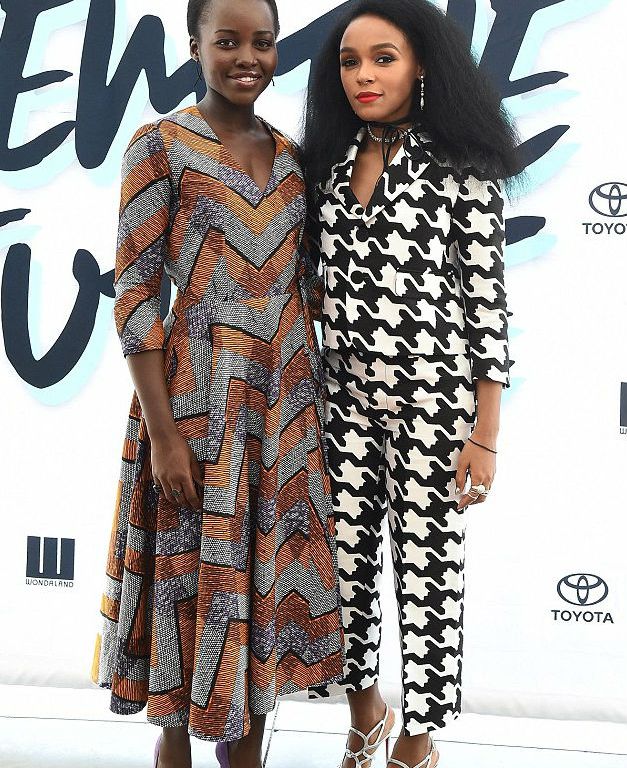 Splurge: Lupita Nyong’o’s Inaugural Fem The Future Brunch DPiperTwins Malia Purple Dress and Janelle Monae’s DSquared Black and White Houndstooth Jacket and Babe Wire Print Trousers