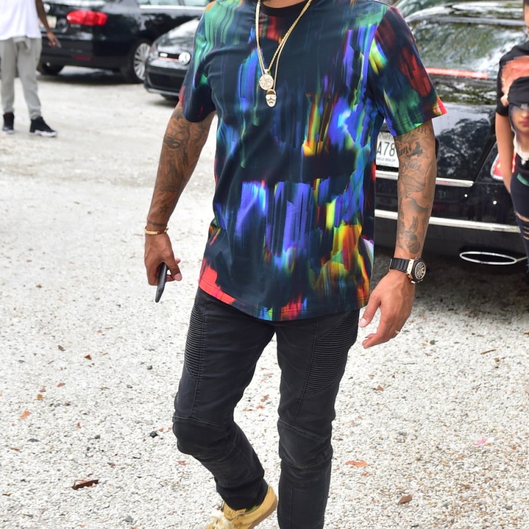 Men’s Fashion Flash: Kenny Burns’s Atlanta Y-3 Hand Painted Effect Multicolor T-Shirt, Black Balmain Jeans, and Maison Martin Margiela Gold Shoes