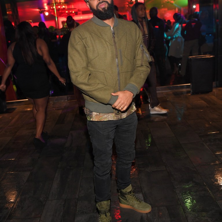 Men’s Fashion Flash: Kenny Burns’s Nelly Compound Valentino Star Motif Olive Green Jacket, Saint Pablo Tour Camouflage Tee, Balmain Jeans. and Nike SF Utility Air Force 1’s