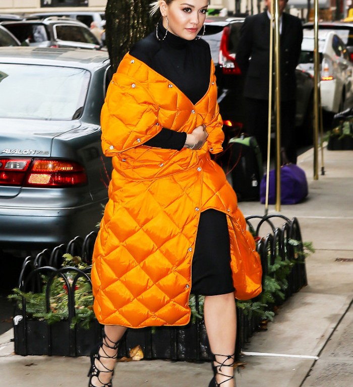 Get The Look: Rita Ora’s New York City James Perse Black Turtleneck Side Slit Dress and Acne Studios Baltimore Orange Quilted Down Coat