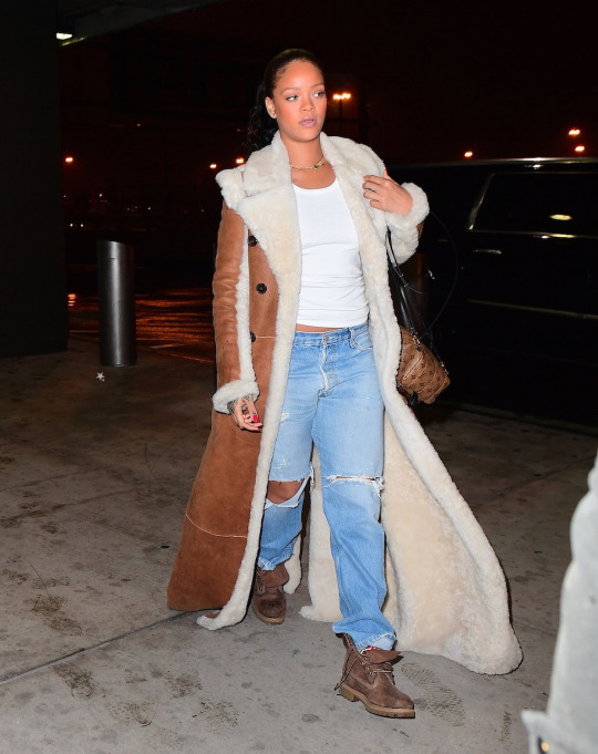Splurge: Rihanna’s JFK Airport Chloe Reversible Shearling Coat, Louis Vuitton Palm Springs Backpack, and Timberland Heritage Boots