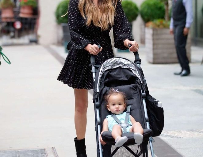 Splurge: Chrissy Teigen’s New York City $590 Zimmermann Black and White Dot Wrap Mini Dress