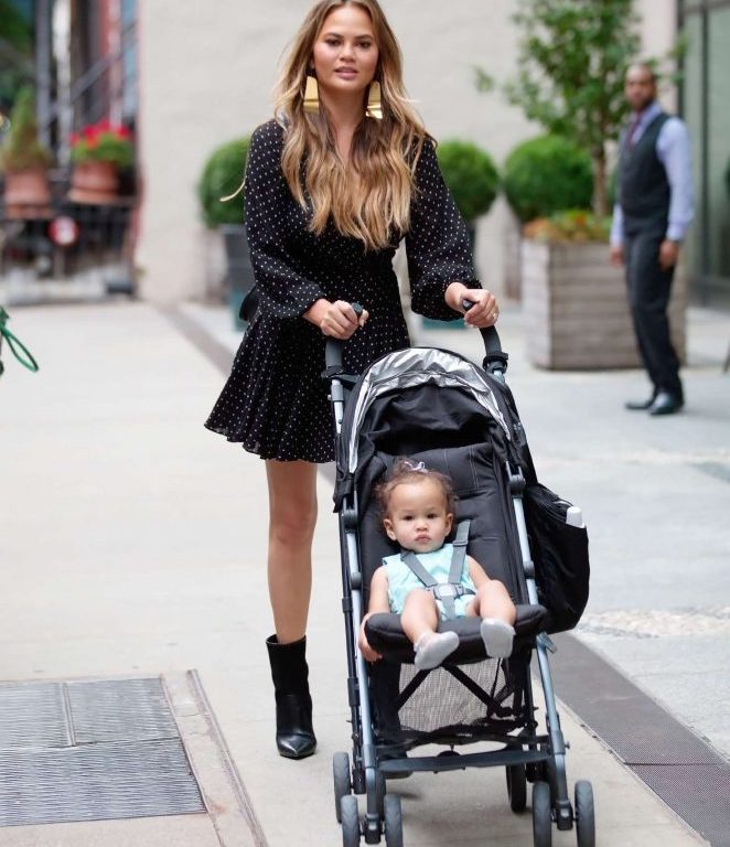 Splurge: Chrissy Teigen’s New York City $590 Zimmermann Black and White Dot Wrap Mini Dress