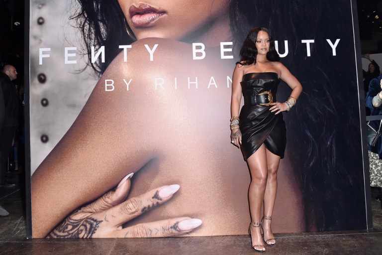 Rihanna Attends Her Fenty Beauty Italy Launch In a Black Strapless Belted Versace FW18 Dress