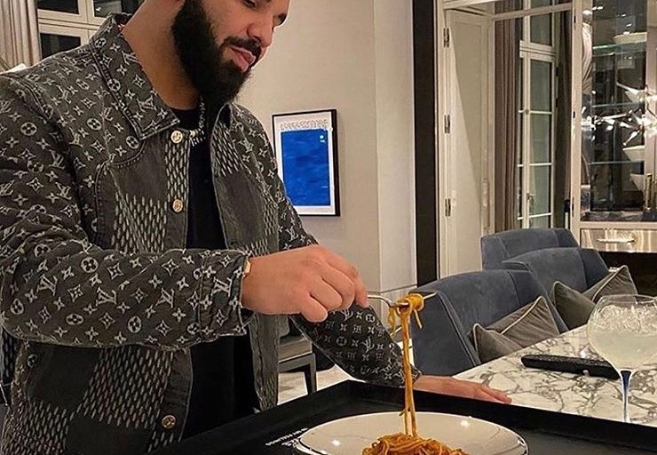 Drake Eats Spaghetti out of his Spotify Plaque Wearing a $2,670 Louis Vuitton Giant Damier Waves Monogram Denim Jacket