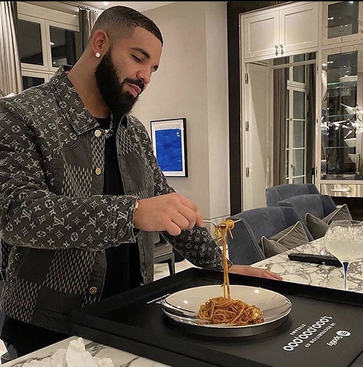 Drake Eats Spaghetti out of his Spotify Plaque Wearing a $2,670 Louis Vuitton Giant Damier Waves Monogram Denim Jacket