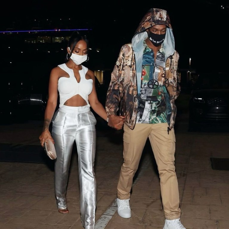 Latoia Fitzgerald Celebrates Los Angeles Lakers Championship With Rajon Rondo in Show-Stopping Look Including White Valery Kōvalska FW20/21 Curved Zip-Up Crop Top and Bottega Veneta Satin Knot Clutch