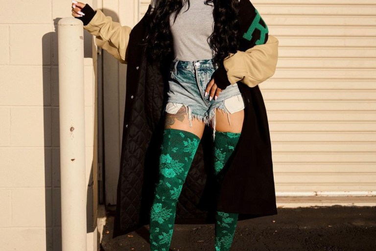 You Ask, We Answer! Monica Rocks a $2,407 Raf Simons FW20 American Letterman Jacket and Balenciaga Green Floral Lace Thigh High Boots