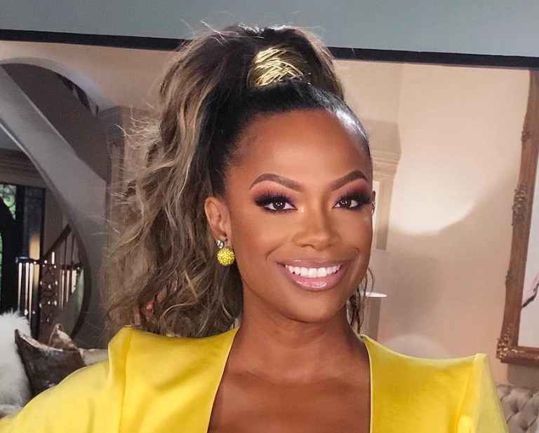 Kandi Burruss Beamed in $2,600 Alex Perry Yellow Satin Gathered Draped Plunging Neckline Dress While on the Set of the Real Housewives of Atlanta