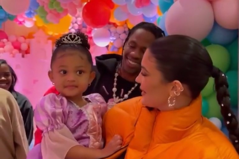 Kylie Jenner Celebrates Her Daughter Stormi’s Third Birthday Wearing an Entire Studios Orange Puffer Jacket, Black and White AMBUSH X Nike Dunk High Sneakers and Hannah Jewett Silver Puddle Play Hoop Earrings