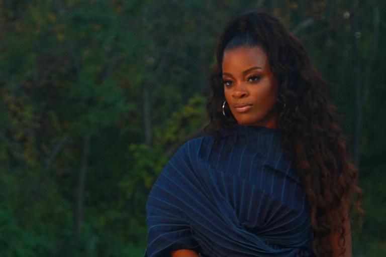 You Ask, We Answer! Ari Lennox Spotted Wearing in Junya Watanabe Navy Pleated Dress in New Music Video