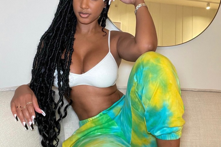 Bernice Burgos Lounges in Fashion Nova Green, Blue and Yellow Tie-Dye Joggers
