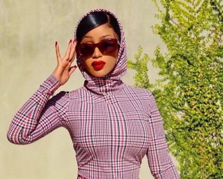 Cardi B Announces the Launch of Her Doll With ‘Real Women Are’ Wearing Burberry Look Including Houndstooth Check-Print Hooded Top and Matching Mini Skirt With Tartan Nylon and Leather Bag