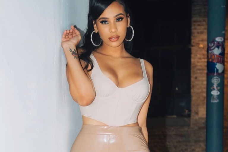 Cyn Santana Posed in Nude Latex Stacked Pants by Fashion Nova