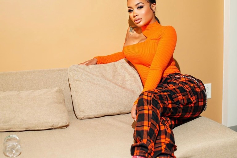 DreamDoll Keeps It Cute and Stylish in Fashion Nova Orange Plaid Joggers