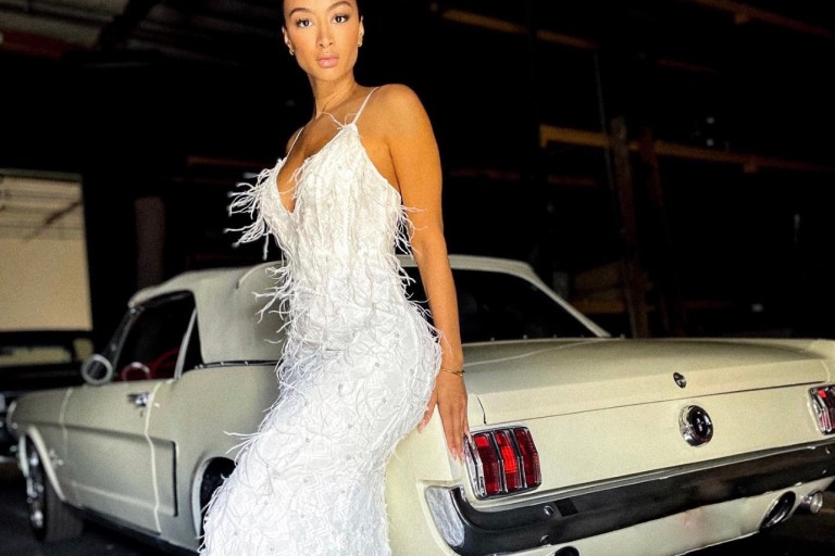Draya Michele Poses in White Feather Embellished Dress by Fashion Nova