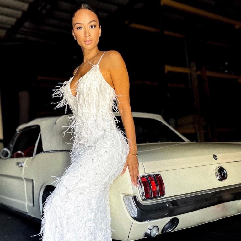 Draya Michele Poses in White Feather Embellished Dress by Fashion Nova