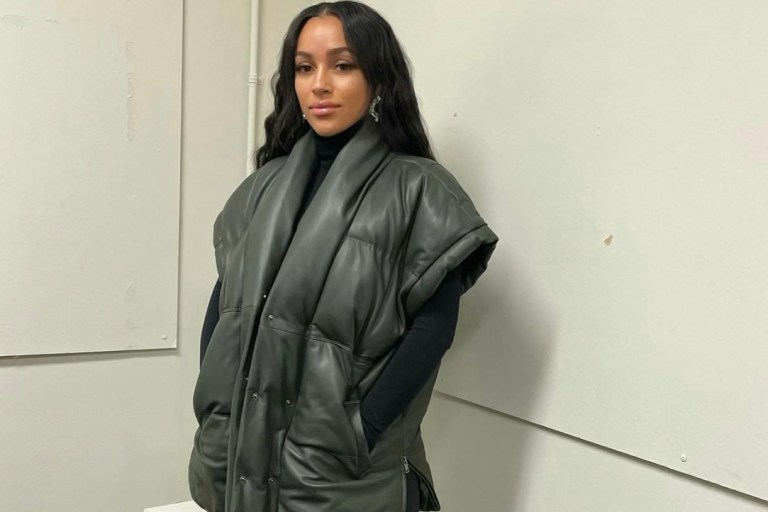 Joie Chavis Keeps It Cozy in Frame Green Puffer Vest, Gianvito Rossi Black Leather Zip-Up Thigh High Boots and Amina Muaddi Crystal Earrings