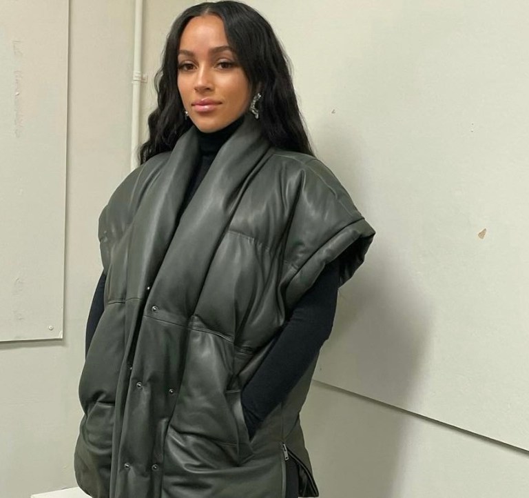 Joie Chavis Keeps It Cozy in Frame Green Puffer Vest, Gianvito Rossi Black Leather Zip-Up Thigh High Boots and Amina Muaddi Crystal Earrings