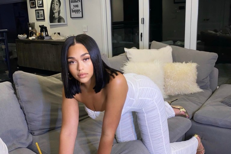 You Ask, We Answer! Jordyn Woods Spotted in I AM GIA White Strapless Mesh Ruched Jumpsuit