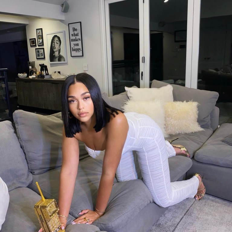 You Ask, We Answer! Jordyn Woods Spotted in I AM GIA White Strapless Mesh Ruched Jumpsuit