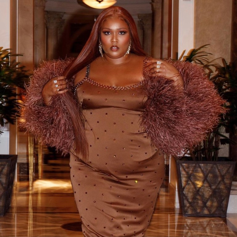 Lizzo Celebrates Her Birthday in Vegas With Glamorous Looks Including Norma Kamali Sleeveless Ruched White Dress, Roberto Cavalli Fall 2021 RTW High-Low Embellished Dress and Dolce and Gabbana Custom Brown Jeweled Dress