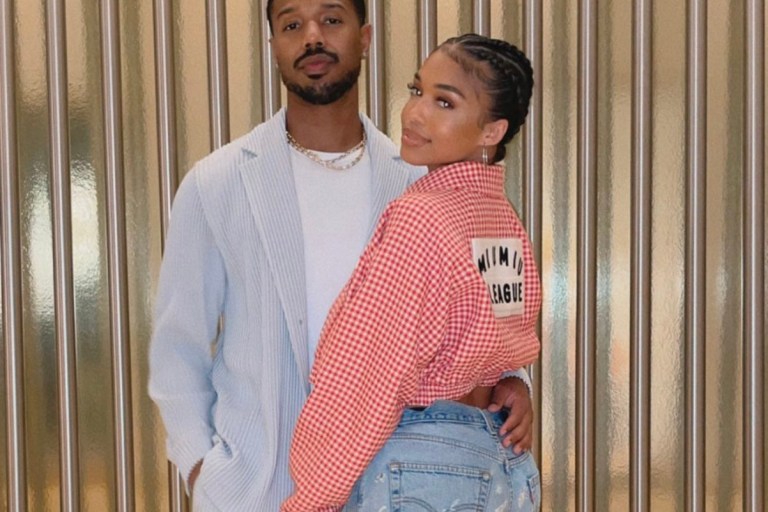 Lori Harvey and Michael B. Jordan Spend Time Together in Vegas: Michael B. Jordan Wears Homme Plissé Issey Miyake Blue Jacket and Pants and Lori Harvey Wears Miu Miu Gingham Jacket, Samaria Leah Distressed Jeans, Loewe Puzzle Bag and Calvin Klein Black and White Heels