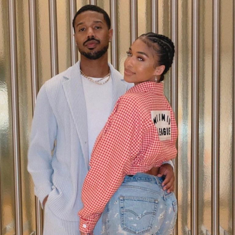 Lori Harvey and Michael B. Jordan Spend Time Together in Vegas: Michael B. Jordan Wears Homme Plissé Issey Miyake Blue Jacket and Pants and Lori Harvey Wears Miu Miu Gingham Jacket, Samaria Leah Distressed Jeans, Loewe Puzzle Bag and Calvin Klein Black and White Heels