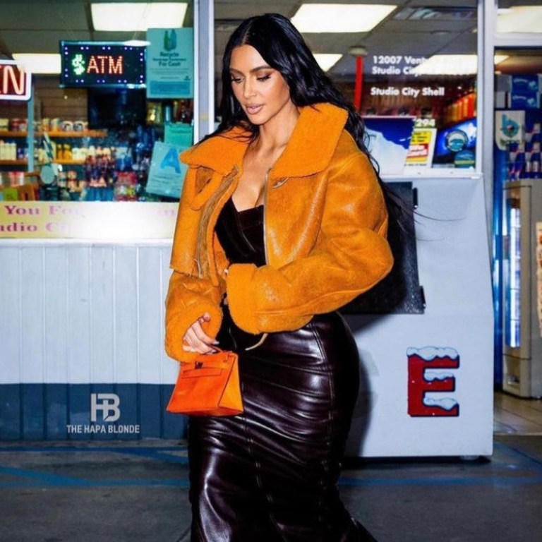 Kim Kardashian Spotted at a Gas Station in LA Wearing Yeezy Orange Shearling Jacket and Dior by John Galliano Brown Leather Strapless Dress