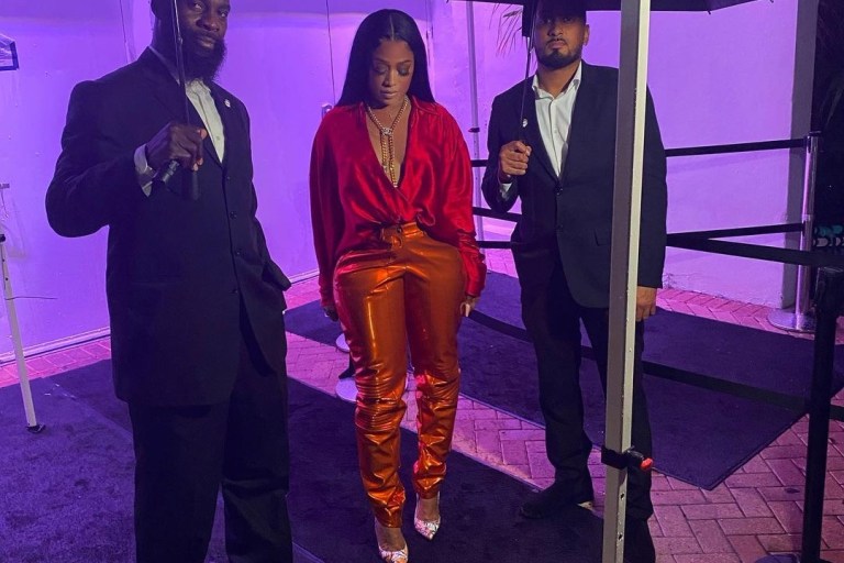 Trina and Eve Verzuz TV Fashion: Trina in LaQuan Smith Spring 2021 Red and Orange Look and Eve in Mugler Black Bodysuit With Paris Texas Green Crystal-Embellished Knee Boots