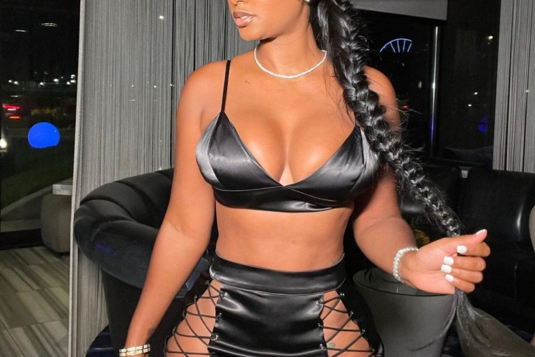 Bernice Burgos Spotted in Chicago Wearing Black Satin Lace-up Skirt Set by Fashion Nova
